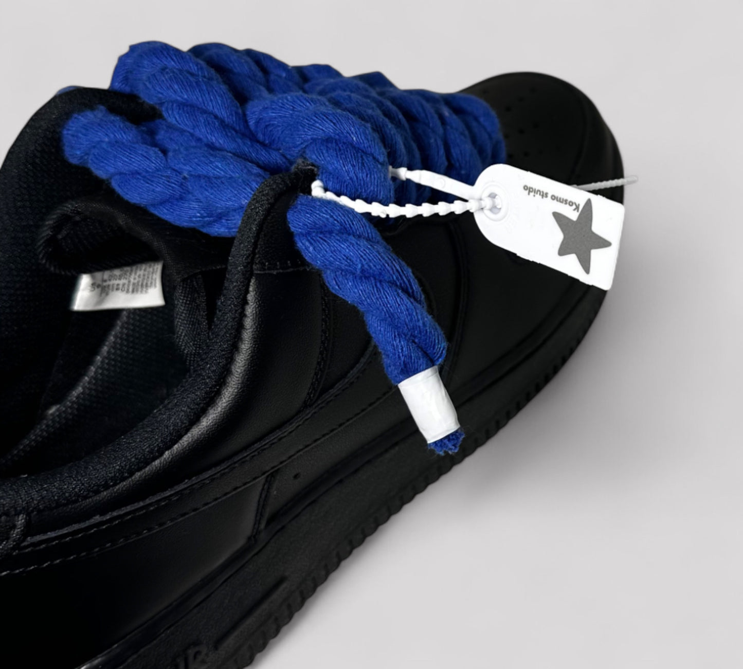 Kosmo studio brand tag on black Nike AF1