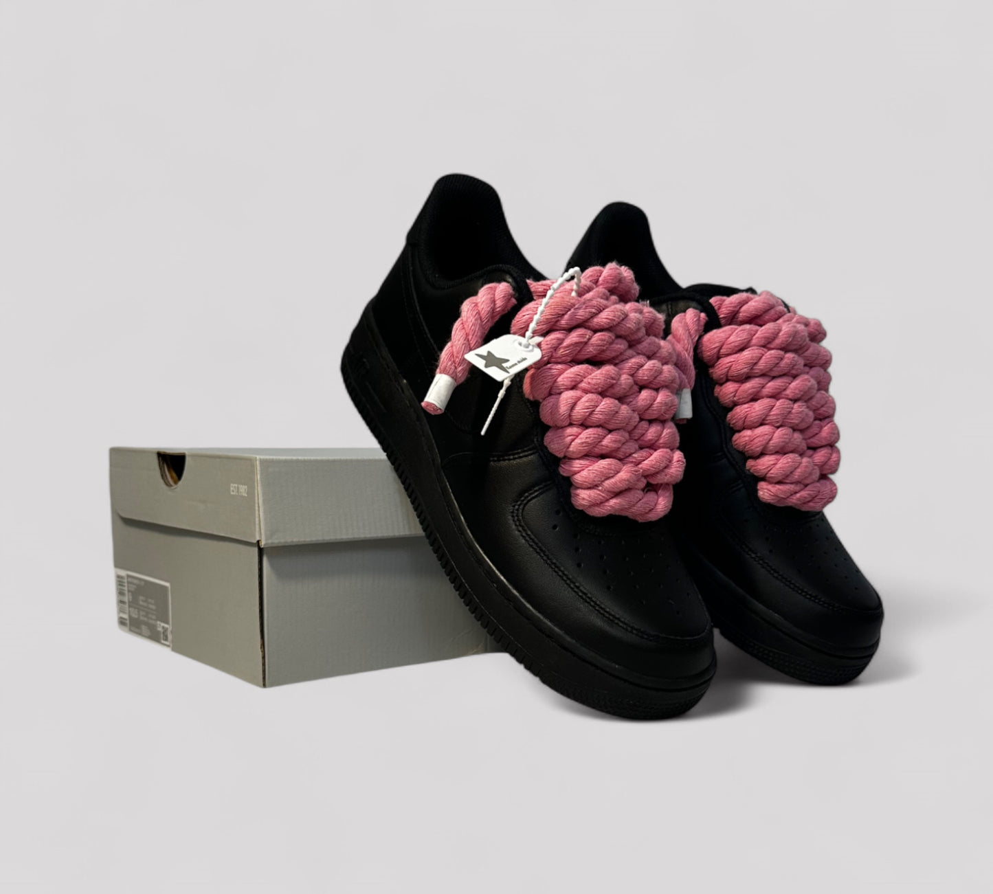Black sneakers with pink rope laces