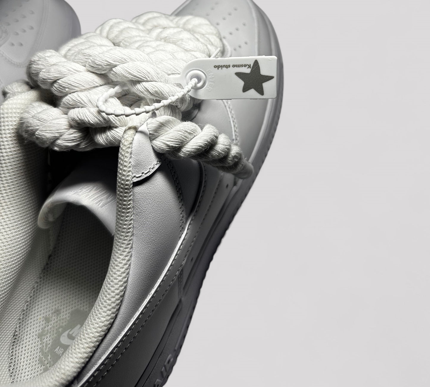 Kosmo studio tag detail on Nike air force 1 rope laces