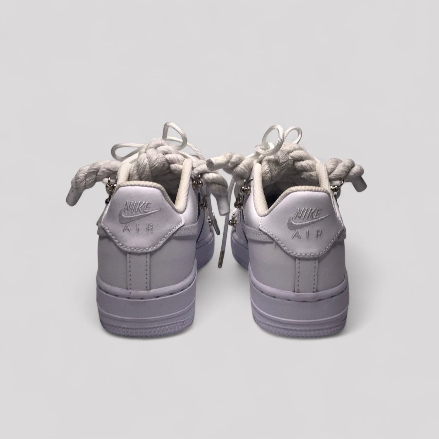 Pair of gray Nike Air sneakers on a light gray background