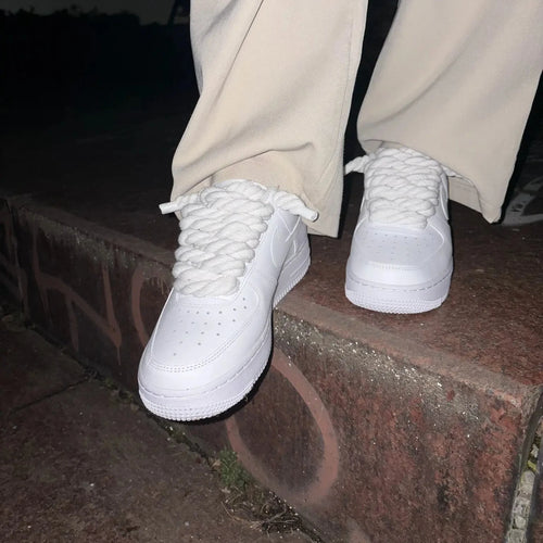 Nike Air Force 1 white with custom rope laces on brick steps