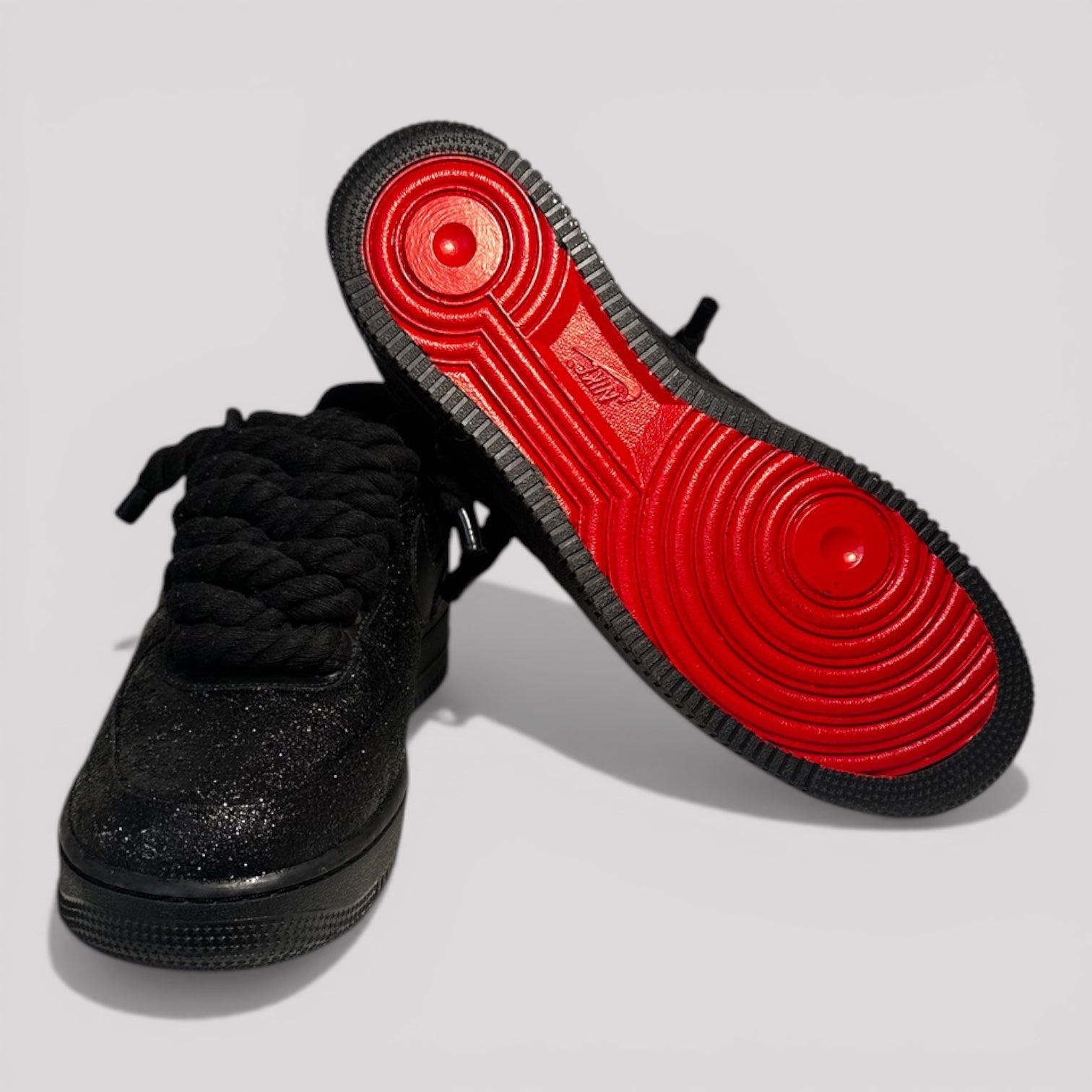 Custom black Nike Air Force 1 black rope laces red sole bottom view