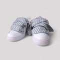 Pair of sneakers with patterned covers on a light gray background