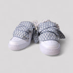 Pair of sneakers with patterned covers on a light gray background