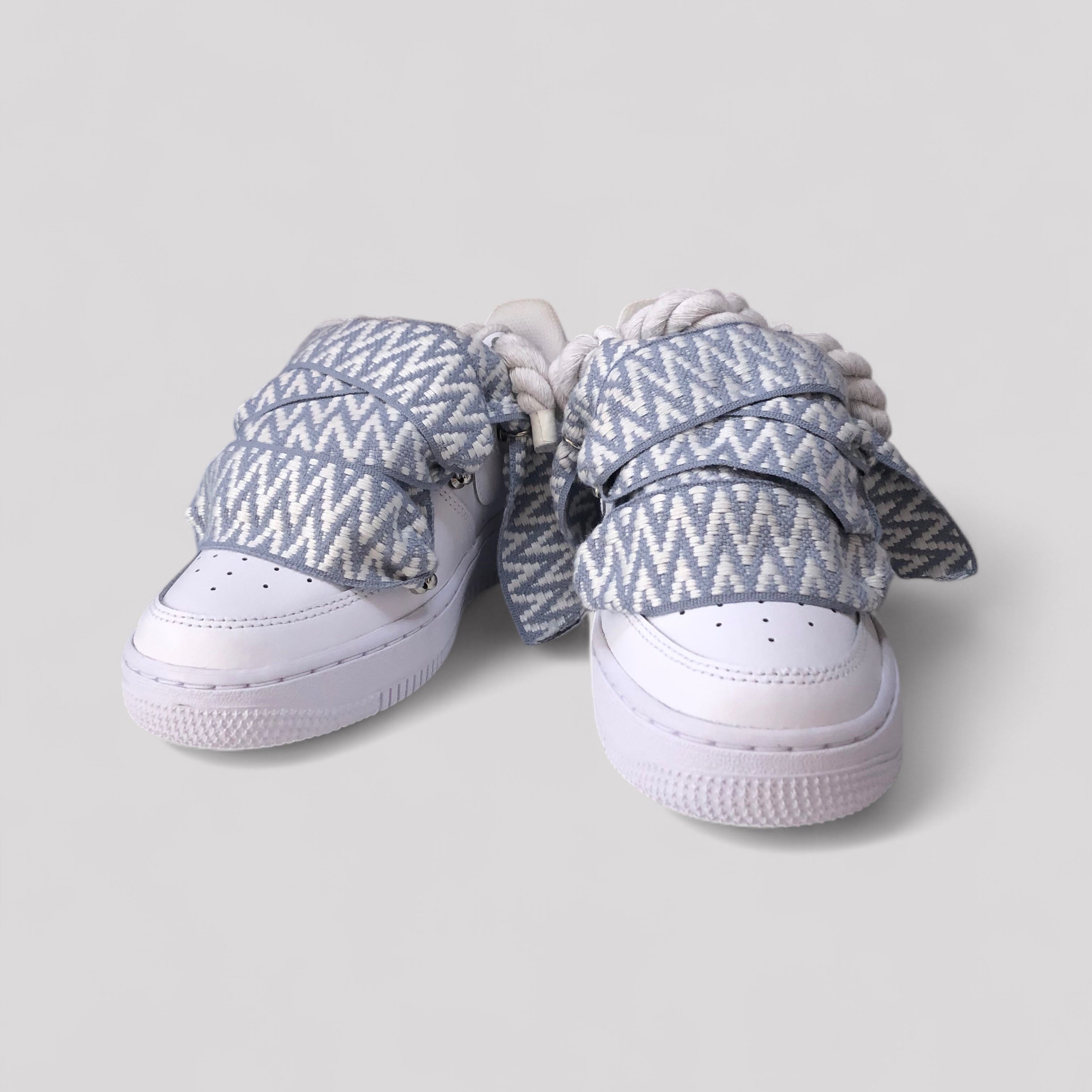 Pair of sneakers with patterned covers on a light gray background