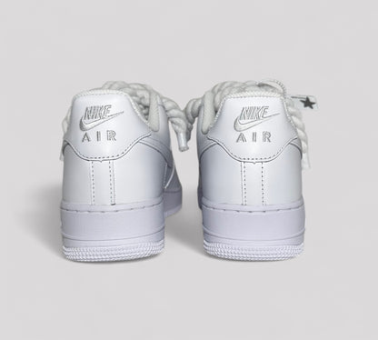 White Nike Air Force sneakers on a light gray background