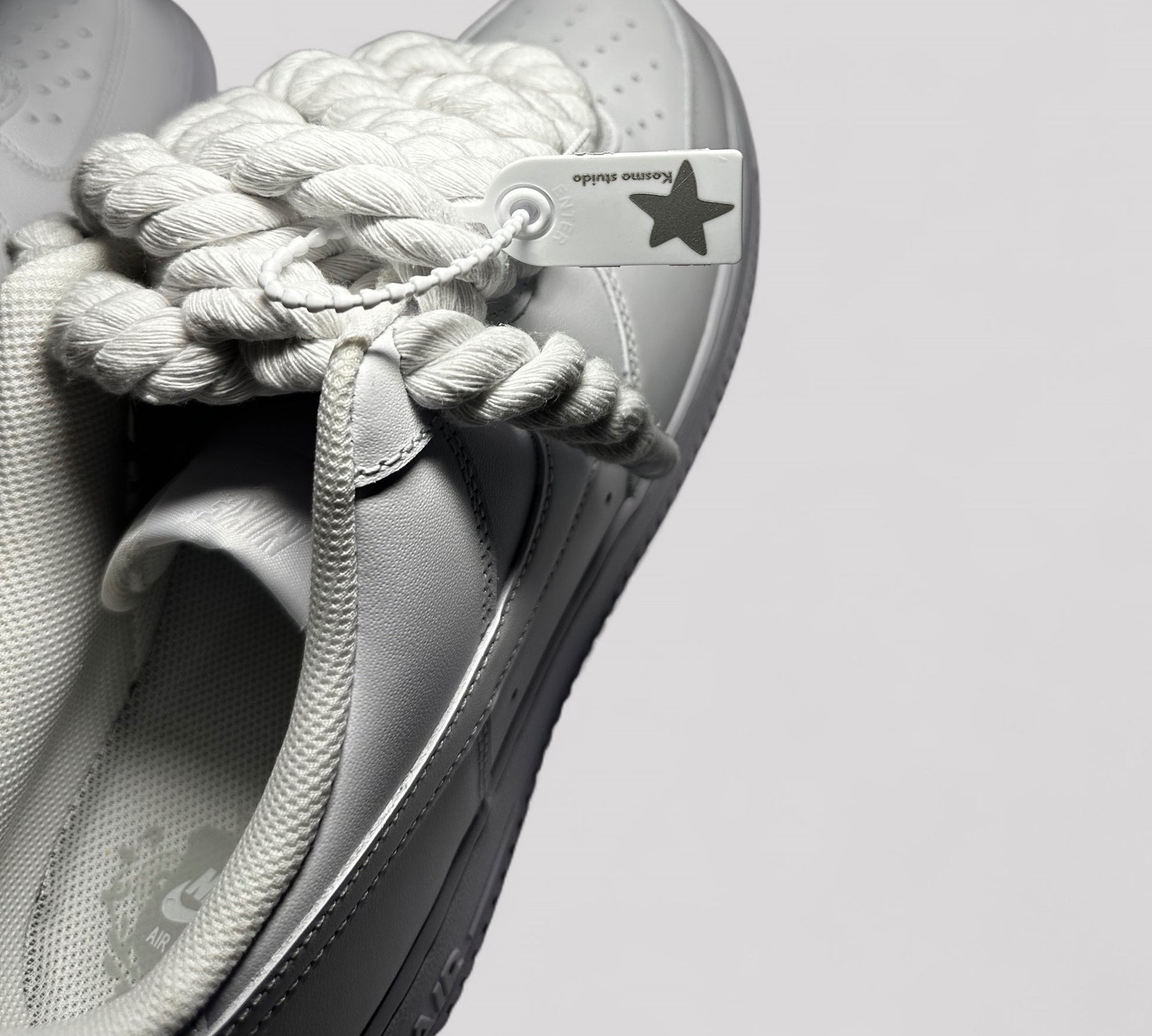 Kosmo studio tag detail on Nike air force 1 rope laces