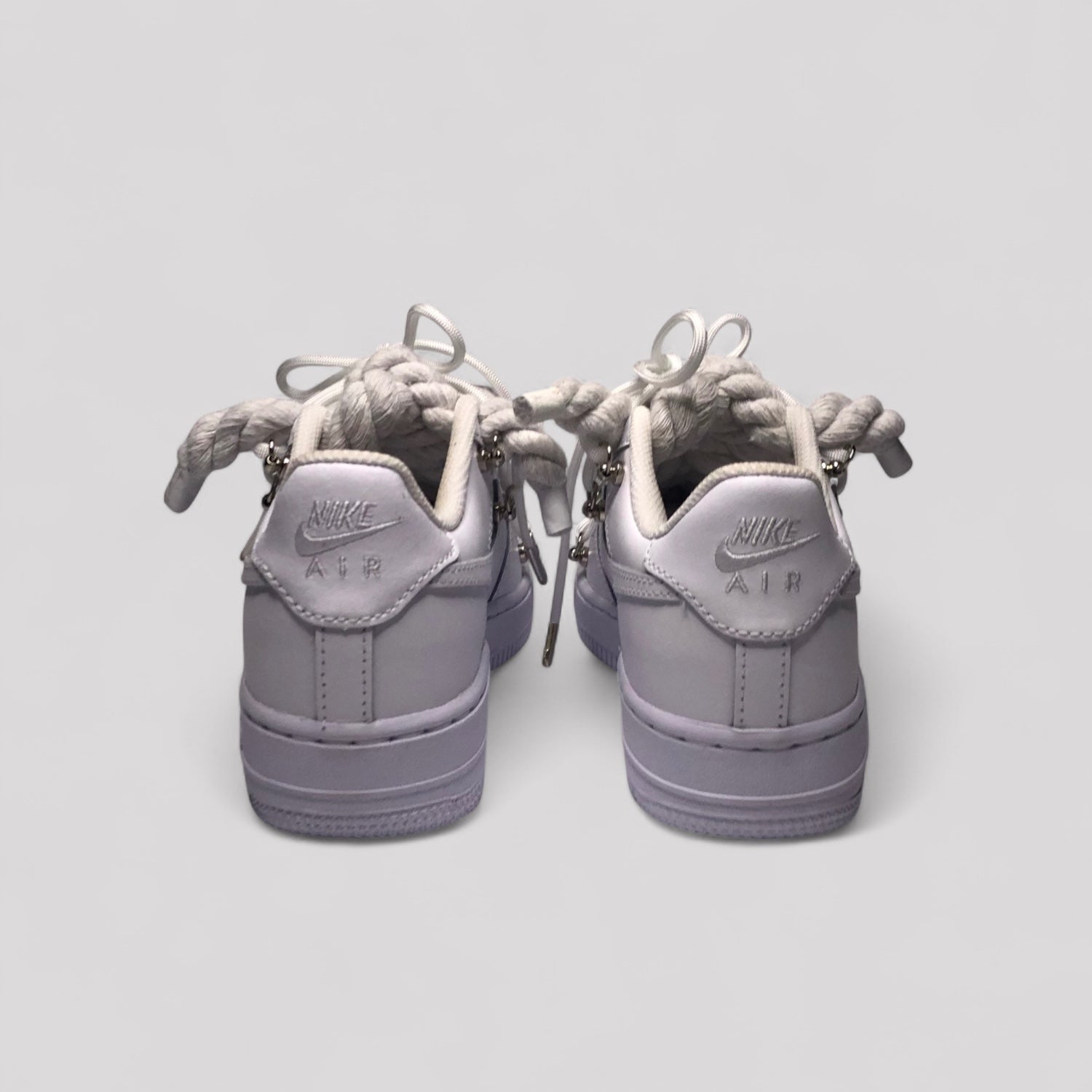 Pair of gray Nike Air sneakers on a light gray background