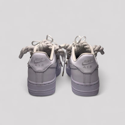 Pair of gray Nike Air sneakers on a light gray background