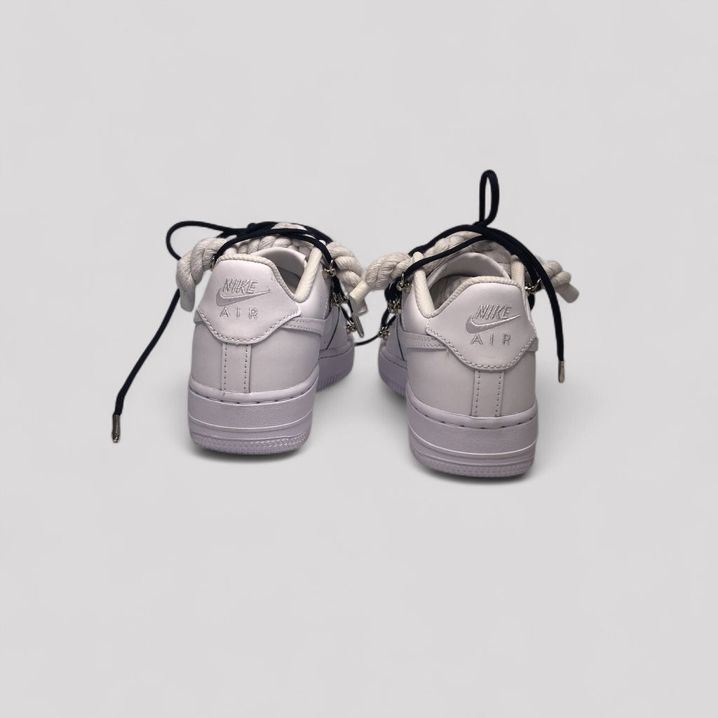 Pair of light purple Nike Air Force sneakers on a white background